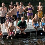 Photo: children jumping into lake
