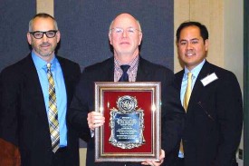 Robson receiving the Dennis Sullivan Award, with (left) nominator Mr. Peter Tabbot, health officer and (right) Dr. Oliver Lontok, NJPHA president.