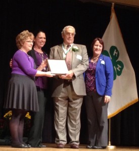 Barr receiving his award from (l-r) Pam Van Horn, president NAE4-HA; Christina Alford, executive vice president, National 4-H Council; and Lisa Lauxman, director, Division of Youth and 4-H, Institute of Youth, Family and Community, NIFA, USDA.