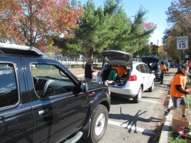 Student volunteers at East Brunswick Freecycling Days direct traffic and unload cars as they pull up to drop off items. Photo by Liti Haramaty