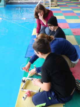 4-H Agent Julie Karavan works with youth on SeaPerch Robotics Project (club photo).