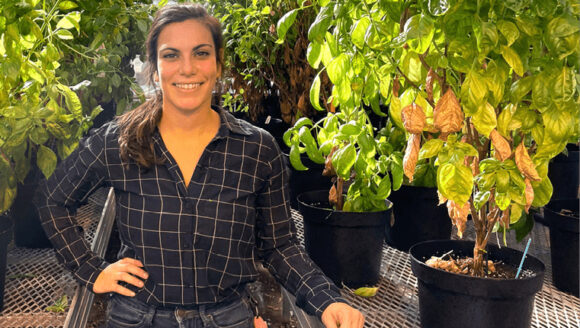 Lara Brindisi posing in front of basil plants