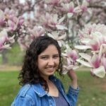 Stephanie Welsh standing by magnolia tree in bloom