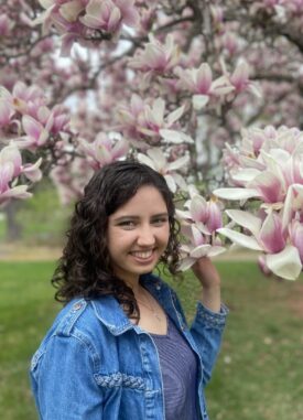 Stephanie Welsh standing by magnolia tree in bloom