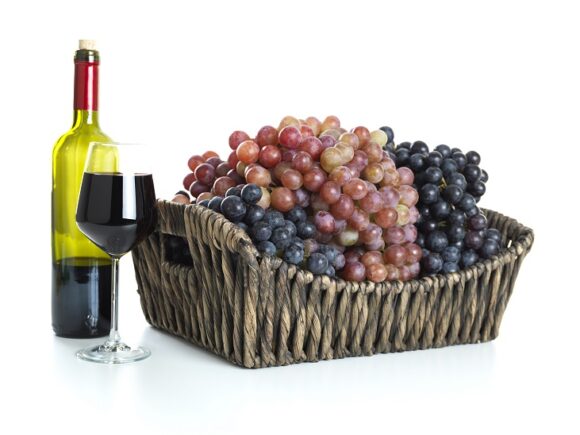 Red wine and red grapes in a basket