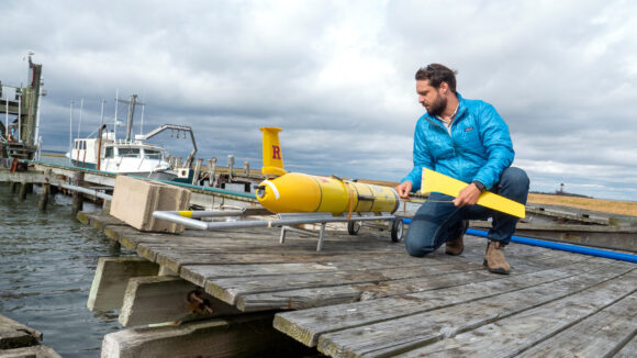 Person inspecting an ocean glider