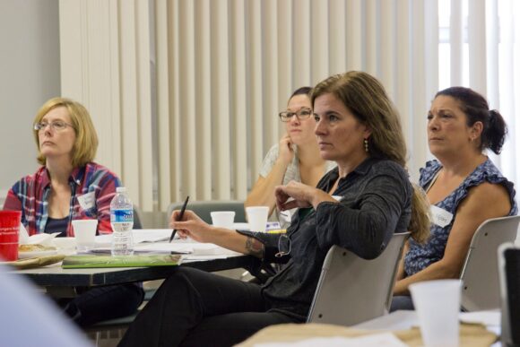 People sitting around a conference room table