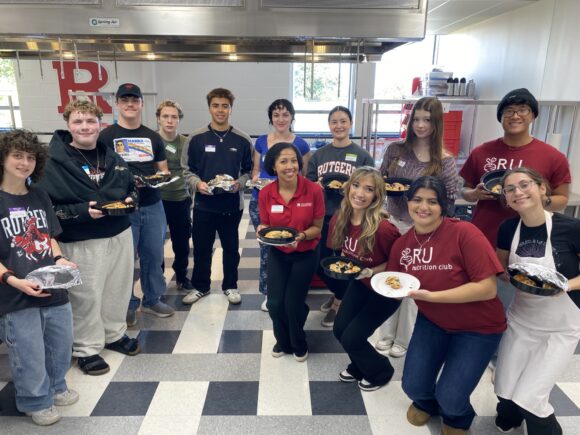 People posing with plates of food