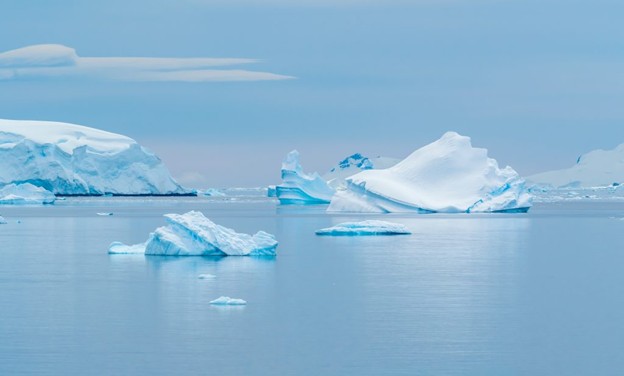 An Arctic landscape of snow-capped ice and body of water