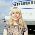 A person standing in front of a ship