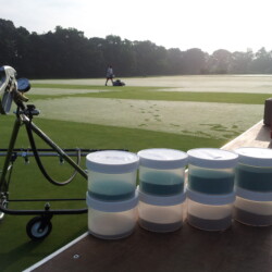 Jars of test fungicides next to research turf