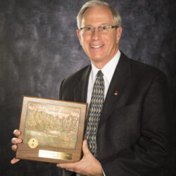Bruce Clarke holding award plaque from U.S. Golf Association