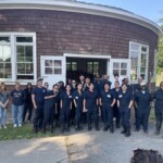 Animal Science Discovery Program students, their Peer Mentors, and Project Coordinator Omar Salas Lopez outside the Roundhouse on the farm.
