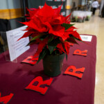 Flowers on a table with Rutgers logo magnets on it