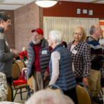 Retirees having conversations at a luncheon