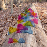 Acrylic pieces connected to a log on the ground