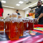 A person selling honey and maple syrup at Rutgers Day