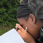 STEM Amb 2025 Newsroom Article - 25 A person using a magnifying glass to look at a bug