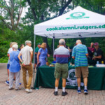 People visiting the Cook College Alumni stand