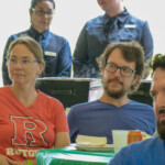 People watching a speaker from their tables
