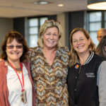 Joyce Carlson takes a joyous photo with two others.