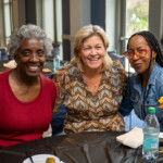 Joyce Carlson takes a joyous photo with two others.