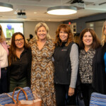 Joyce Carlson takes a joyous photo with five others.