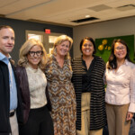 Joyce Carlson takes a joyous photo with five others.
