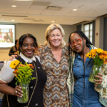 Joyce Carlson takes a joyous photo with two others.