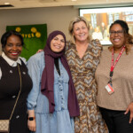 Joyce Carlson and three others smile at her retirement party.