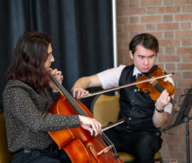 Two people playing classical string instruments